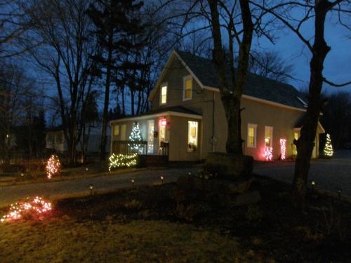 a house with christmas lights on the front of it at Rothesay Motel in Rothesay