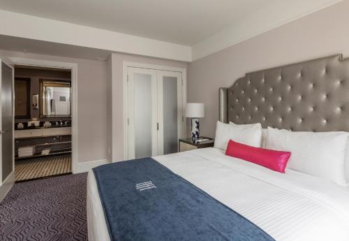a bedroom with a large bed with a red pillow at The Read House Hotel in Chattanooga