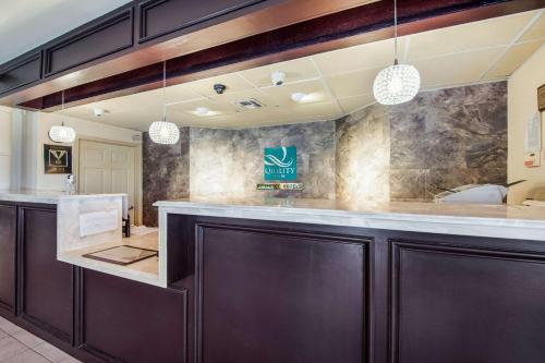 a bar in a dental office with two pendant lights at Quality Inn Bastrop in Bastrop