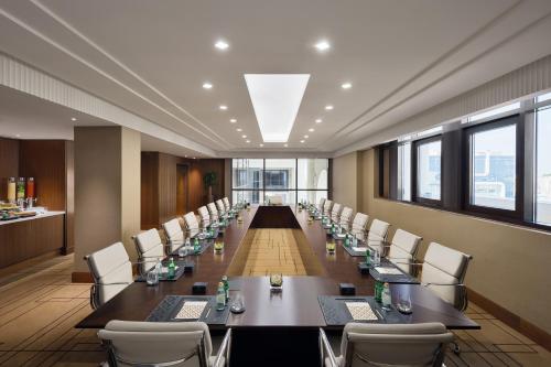 a large conference room with a long table and chairs at The Hotel Galleria Jeddah, Curio Collection by Hilton in Jeddah