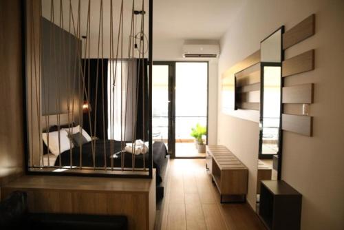 een woonkamer met een bed en een grote spiegel bij Super Stylish Apartments in the Heart of Athens! in Athene