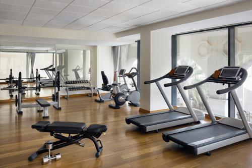 a gym with several treadmills and exercise machines at The Hotel Galleria Jeddah, Curio Collection by Hilton in Jeddah