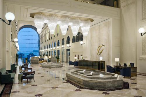 a lobby with a fountain in the middle of a building at The Hotel Galleria Jeddah, Curio Collection by Hilton in Jeddah