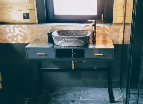a bathroom sink with a metal bowl on a counter at Koniakowo - dom Hunter in Koniaków
