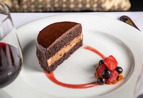 a piece of chocolate cake and berries on a white plate at The Read House Hotel in Chattanooga