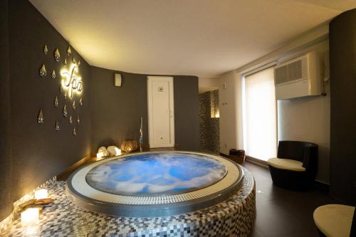 a bathroom with a large blue tub in a room at Wellness penzion U Grygarů in Lipník nad Bečvou