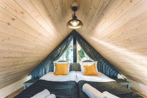 um pequeno quarto com duas camas numa casa na árvore em Domek na drzewie Oddech em Nałęczów
