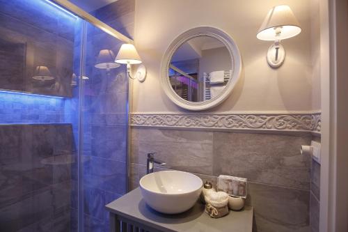 a bathroom with a sink and a mirror at Luxury Suite in Rimini