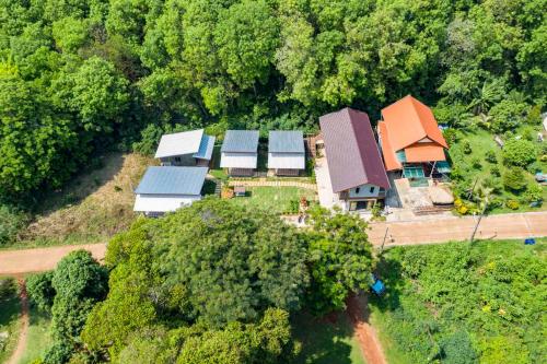 an overhead view of a group of houses with trees at Hanoii House in Ko Mak