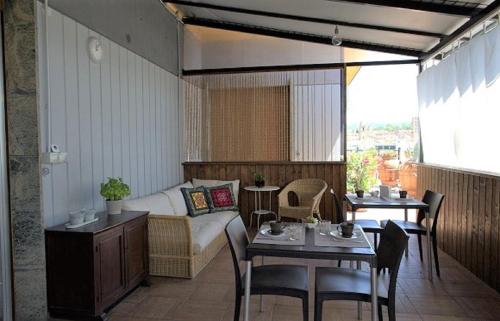 a living room with a couch and a table and chairs at B&B Cameracaffè Centro in Arezzo