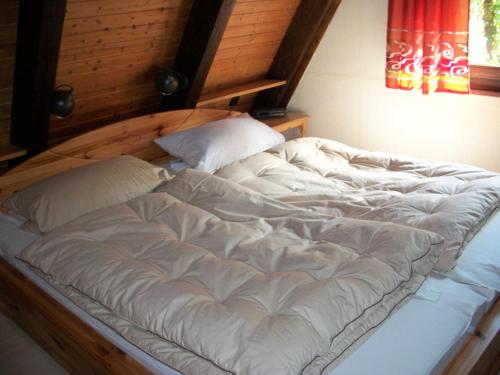 a large white bed with two pillows on it at Ferienhaus Kirschblüte in Ronshausen