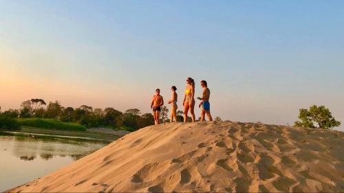 a group of people standing on top of a sand mound at Savet Guesthouse in Stœ̆ng Trêng