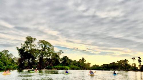 a group of people ridingogie boards in a river at Savet Guesthouse in Stœ̆ng Trêng