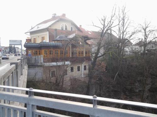 a house on the side of a road with a fence at Guest House Arvaj in Kranj