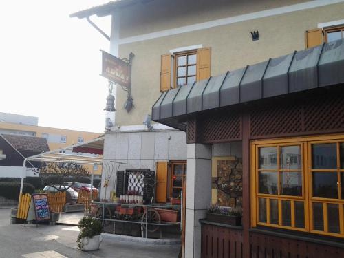 a store with a sign on the side of a building at Guest House Arvaj in Kranj