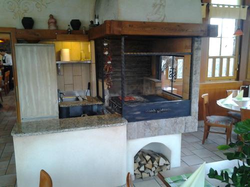 a kitchen with a large fireplace in a restaurant at Guest House Arvaj in Kranj