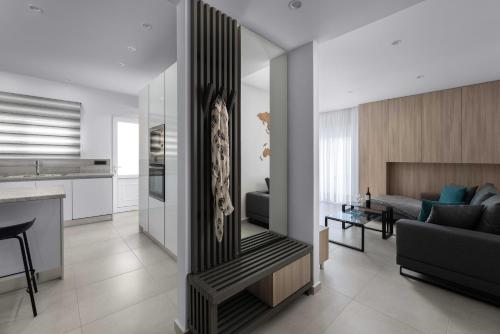 a living room and kitchen with a couch and a table at Kallia Sea Breeze - 3 Bedroom Apartment in Rhodes Town