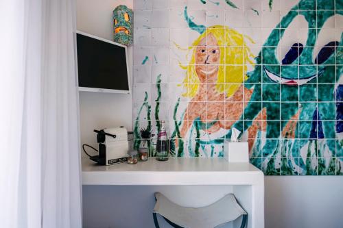 a desk in a room with a wall at Hôtel La Reine Jane in Hyères