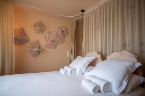 a bedroom with two beds with towels on them at Hôtel La Reine Jane in Hyères