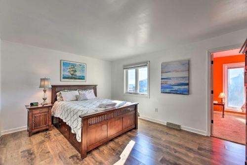 a bedroom with a bed with a wooden bed frame at West of the Moon Ocean Apt with Beach Access! in Emerald Isle