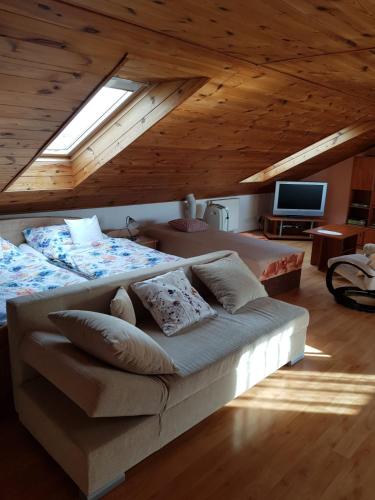 a large bed in a room with a wooden ceiling at Apartmán v rodinném domě in Hradec Králové