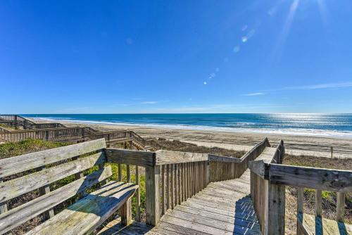 a wooden boardwalk to a beach with the ocean at 1 Ocean Fun Emerald Isle Apt, Steps to Beaches! in Emerald Isle
