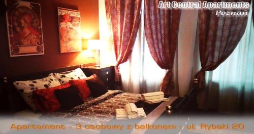 a bedroom with a bed and a window with curtains at Art Apartments in Poznań