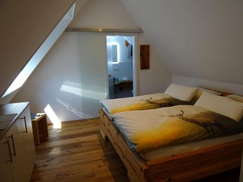 a bedroom with two beds and a staircase at Ferienwohnungen Schwarzwaldtraum in Unterkirnach