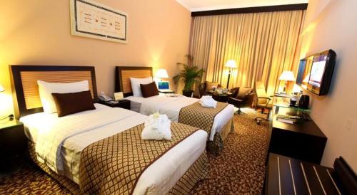 Ένα ή περισσότερα κρεβάτια σε δωμάτιο στο Dorus Hotel