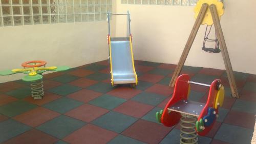 a childrens play room with a slide and a chair at Hotel Yeste in Yeste