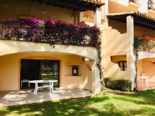 a patio with a table and flowers on a building at Apartamentos El Toro in Marbella