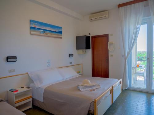 Postel nebo postele na pokoji v ubytování Hotel Pari