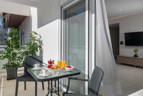 a table with a bowl of fruit on a balcony at Kallia Sea Breeze - 3 Bedroom Apartment in Rhodes Town
