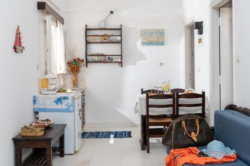 a living room with a blue couch and a table at Margarita Apartments in Ierápetra