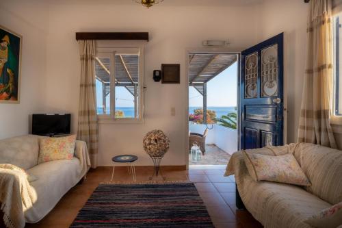 a living room with a view of the ocean at Margarita Apartments in Ierápetra
