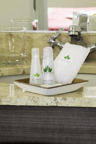 two bottles on a plate on a counter at Geotel Antofagasta in Antofagasta