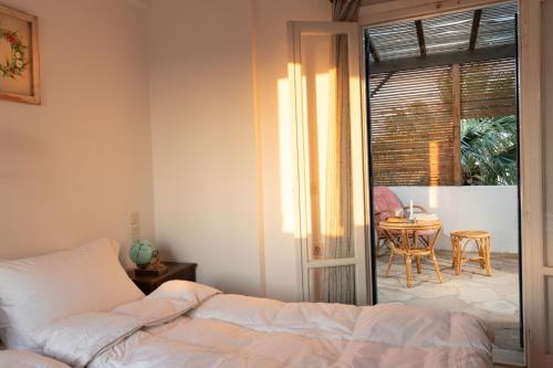 a bedroom with a bed and a table at Margarita Apartments in Ierápetra