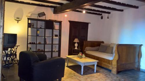 a living room with a couch and a table at Sole e Ventu 90qm in San-Giovanni-di-Moriani