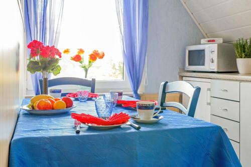 a table with a blue table cloth and fruit on it at Ferienwohnung Itzehoe in Itzehoe