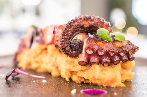 a close up of a dessert with an octopus on it at Clement Barajas in Madrid
