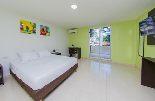 a bedroom with a bed and a television in it at Hotel Avexi Suites By GEH Suites in Cartagena de Indias