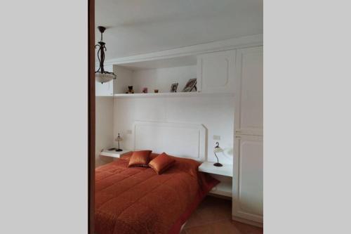 a bedroom with a bed with two pillows on it at FORT Montagna Casa Impero CIR 06678CVP0002 in Rivisondoli