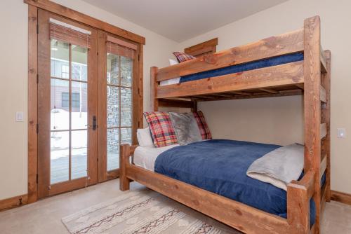 a bedroom with two bunk beds and a door at Lodges 1140 in Old Mammoth