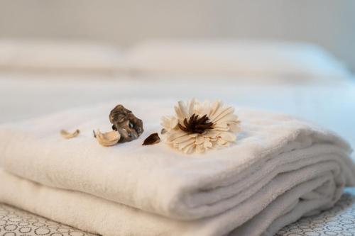 a white towel with a flower on top of it at casa dolce casa in Rome
