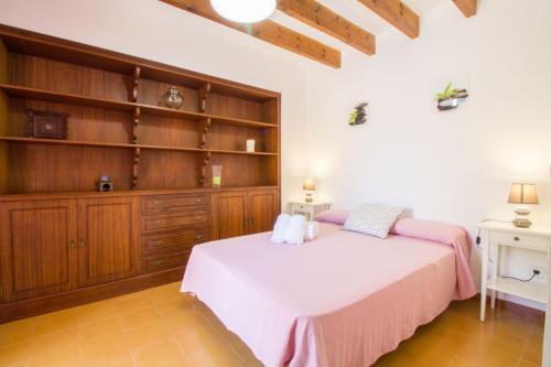 a bedroom with a bed and a book shelf at Casa típica Mallorquina con mucho encanto in Santanyi