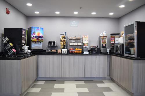 a restaurant with a counter with a coffee machine at Microtel Inn & Suites by Wyndham Raleigh in Raleigh