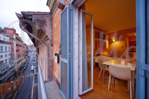 a room with a balcony with a view of a city at Ripetta 25 Prestige Rooms in Rome