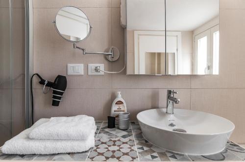 a bathroom with a sink and a mirror at New Luxus Apartment in Gaeta with sea view on harbour in Gaeta