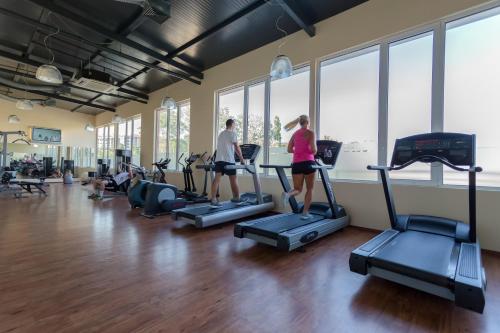 two people walking on treadmills in a gym at DIT Majestic Beach Resort - Ultra All Inclusive in Sunny Beach