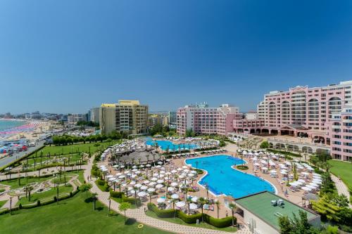 an aerial view of a resort with a pool and umbrellas at DIT Majestic Beach Resort - Ultra All Inclusive in Sunny Beach
